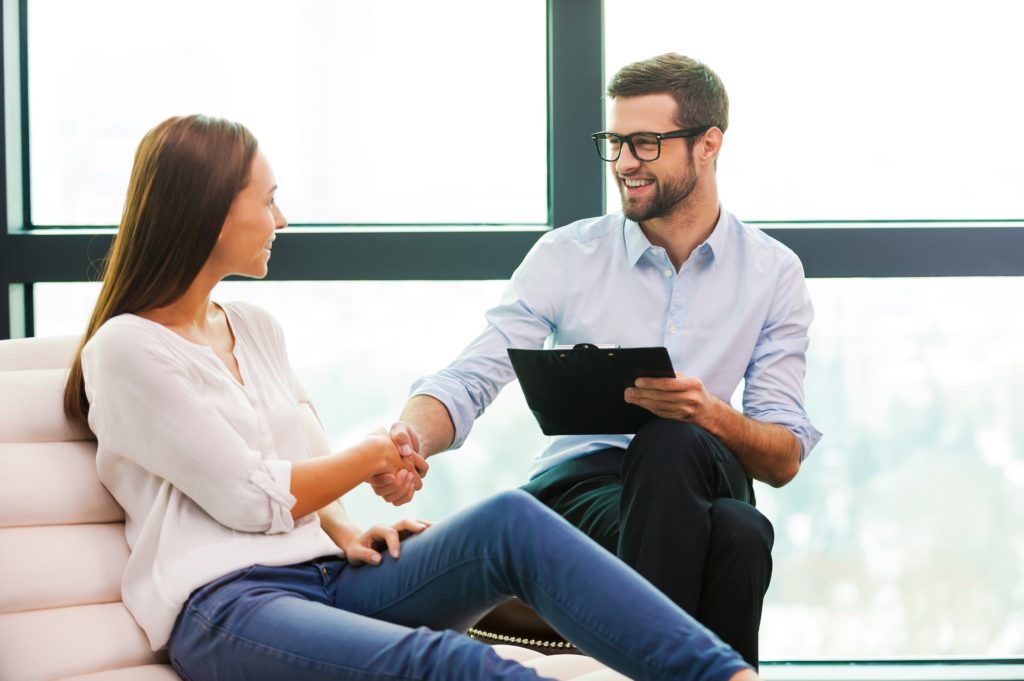 Photo of two people concluding a meeting with a handshake.