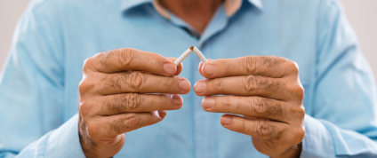 Image of a person breaking a cigarette in half